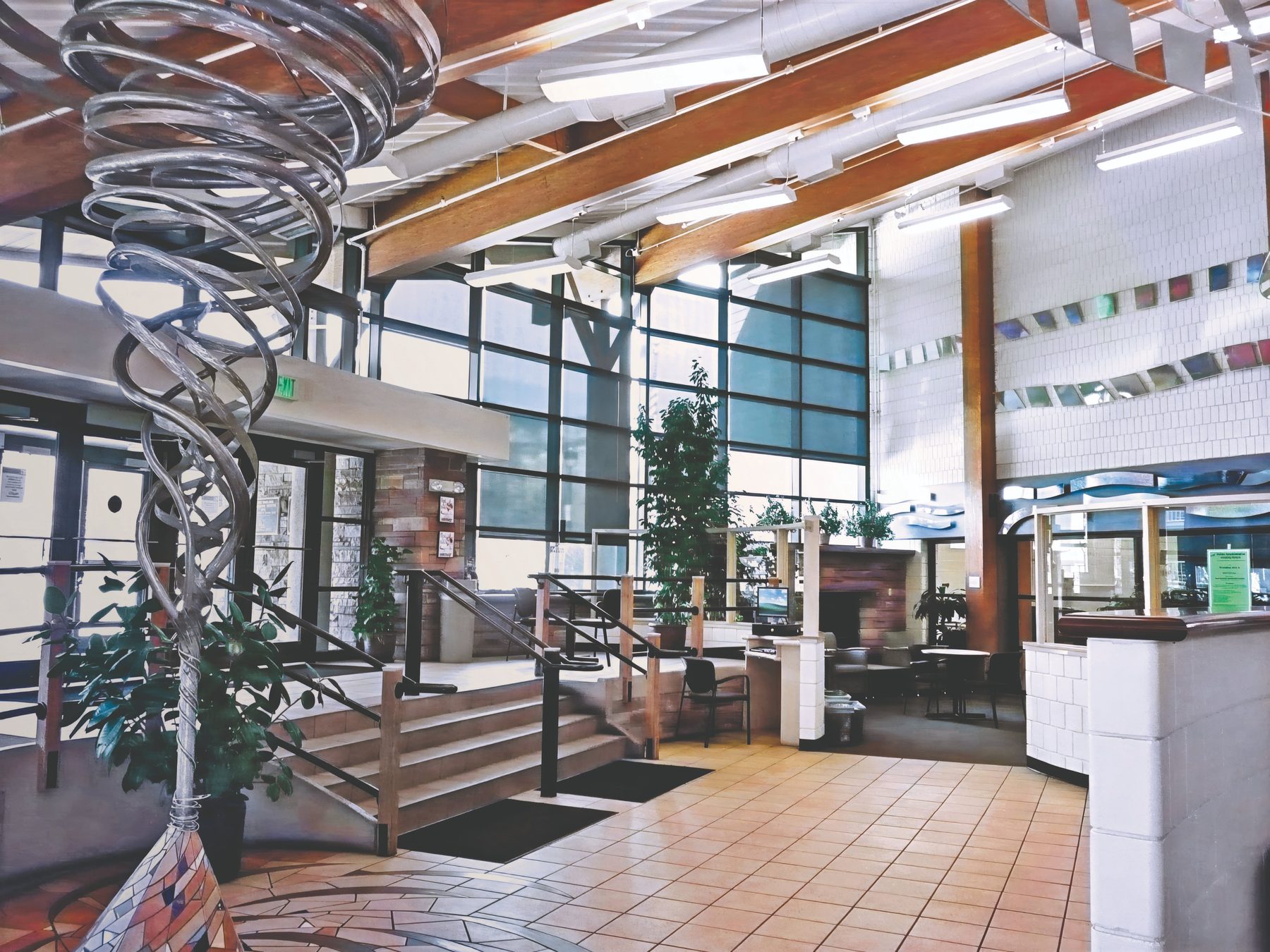 Tall interior window shades in a two-story lobby, light control for large glass in Frisco offices and public rooms