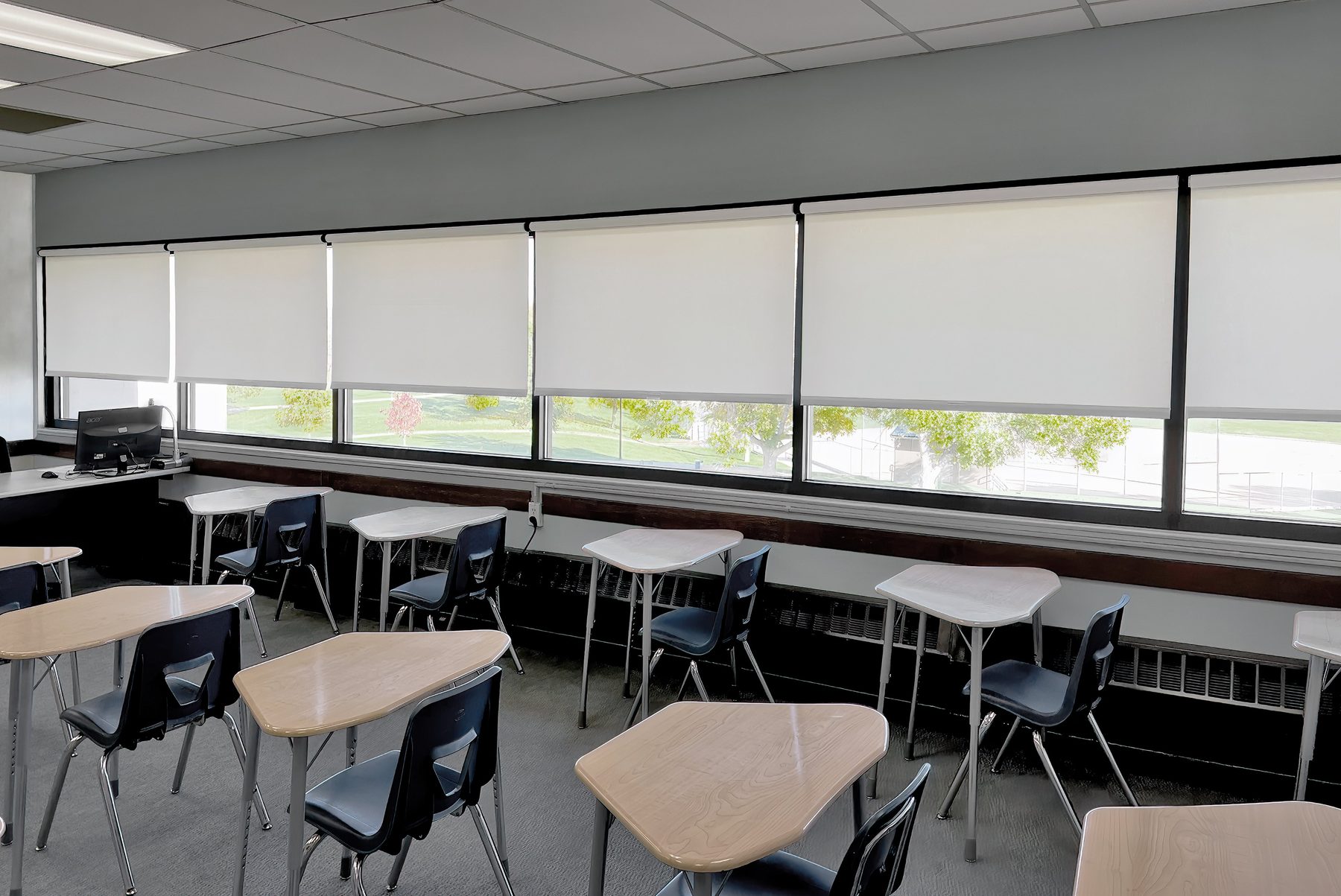 White interior roller shades on a classroom window band, light control for schools and training rooms in Celina, Prosper, and Gunter