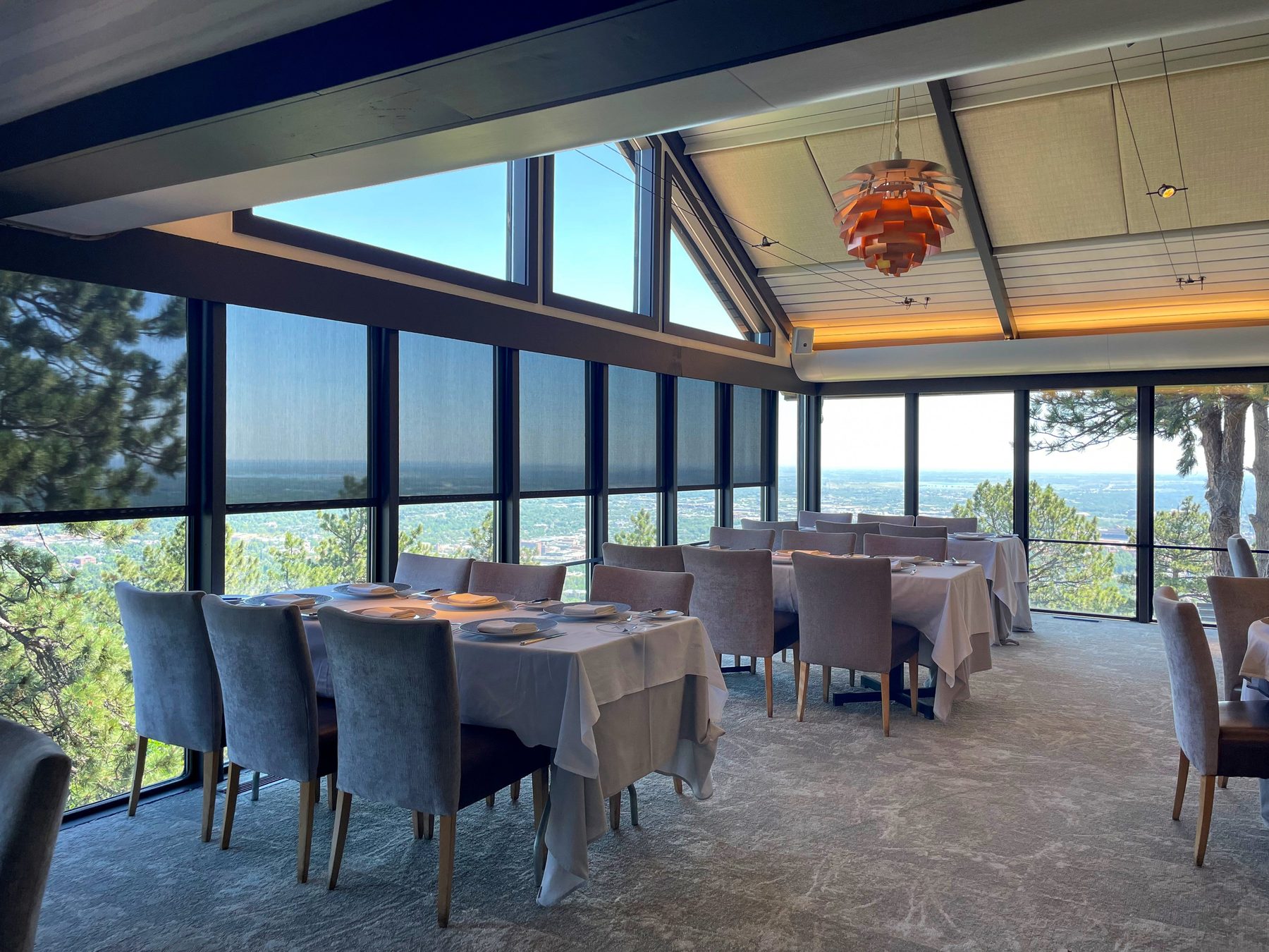 Interior solar shades on tall dining windows that keep a view while cutting afternoon sun, the treatment we specify for west rooms in Celina and Prosper