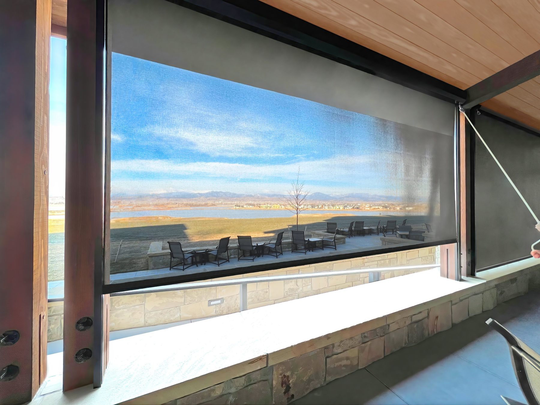 Wide exterior solar screen on a covered patio that keeps the view while cutting glare, a setup we specify for acreage homes in Celina and Gunter